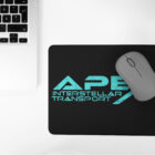 Black Mouse Pad Teal Apex Interstellar Transport Logo next to laptop computer