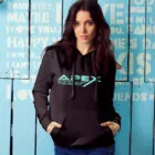 Woman wearing Black pullover Hoodie with Apex Interstellar Transport logo in teal blue front
