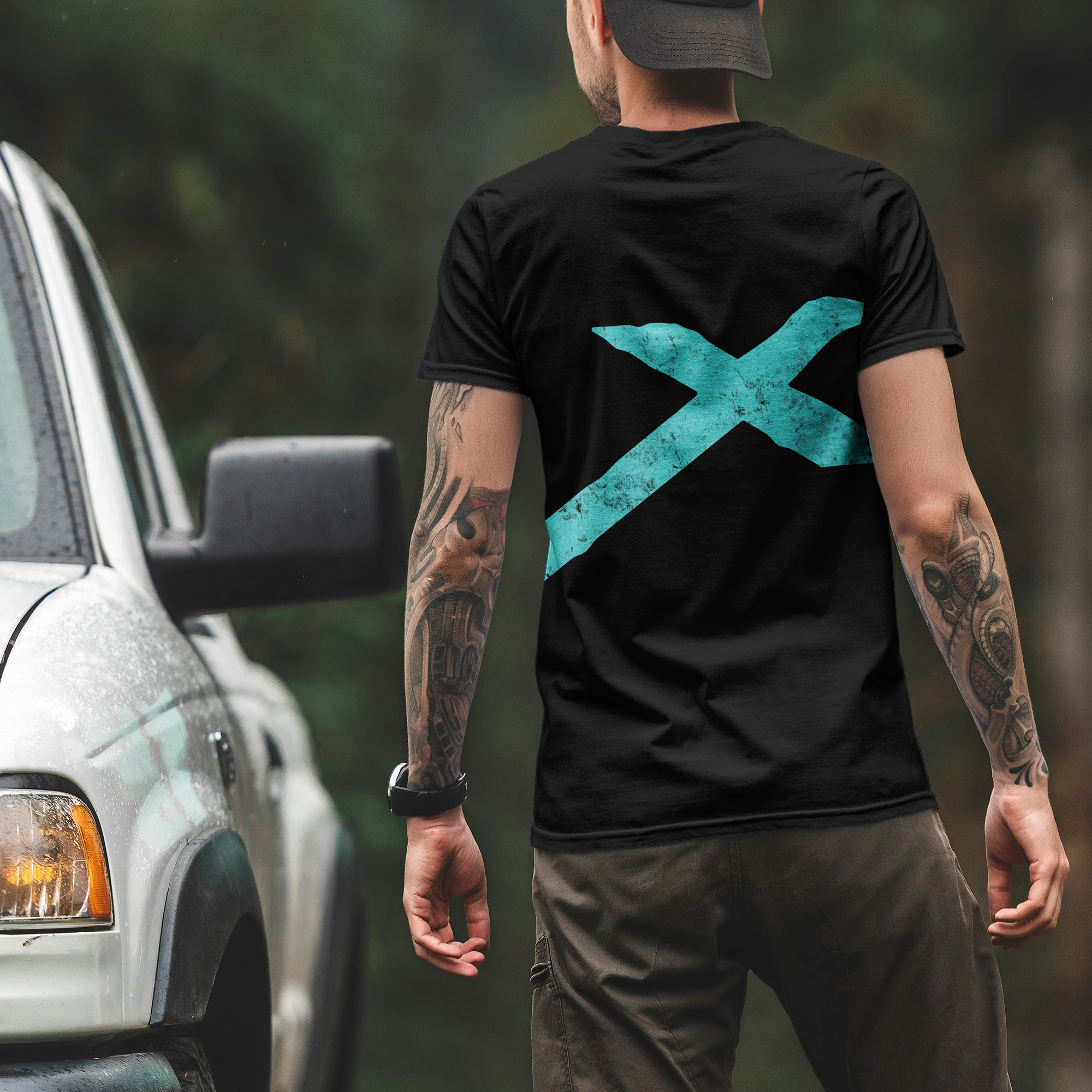 Man wearing Black T-Shirt with Apex Interstellar Transport logo in teal blue back