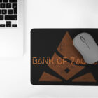 Black Mouse Pad with Bank of Zaonce logo in orange next to laptop computer