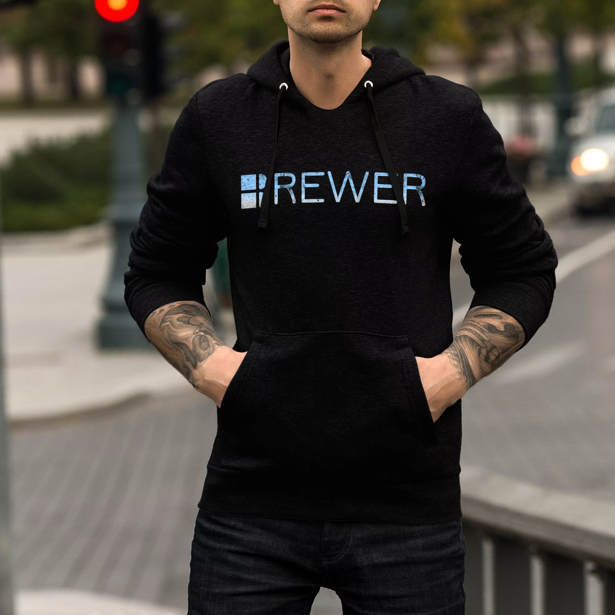 Man wearing black Brewer Pullover Hoodie with street in background