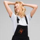 Embroidered Bank of Zaonce patch logo in orange on overalls worn by woman