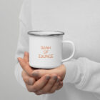 Woman holding Bank of Zaonce Enameled Mug with orange text and stainless steel brim