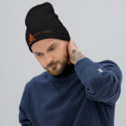 Man wearing Black Beanie with orange Embroidered logo of Bank of Zaonce front view.